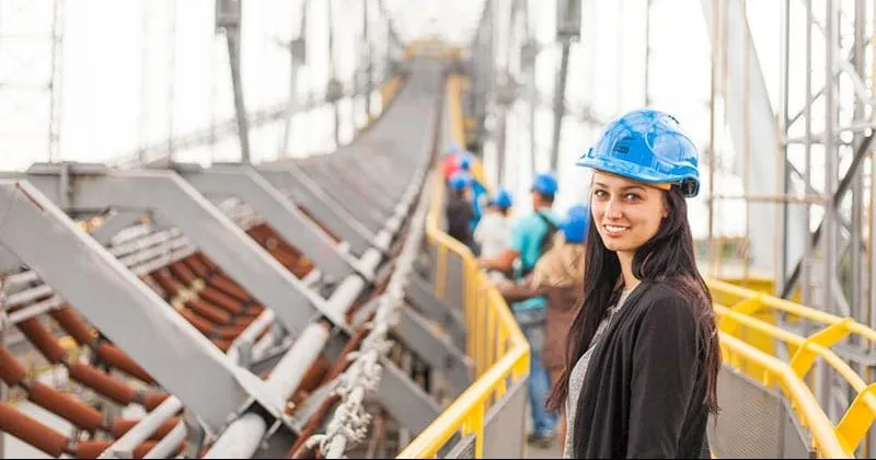 Woman standing on metal bridge - Evolved role of quantity surveyor