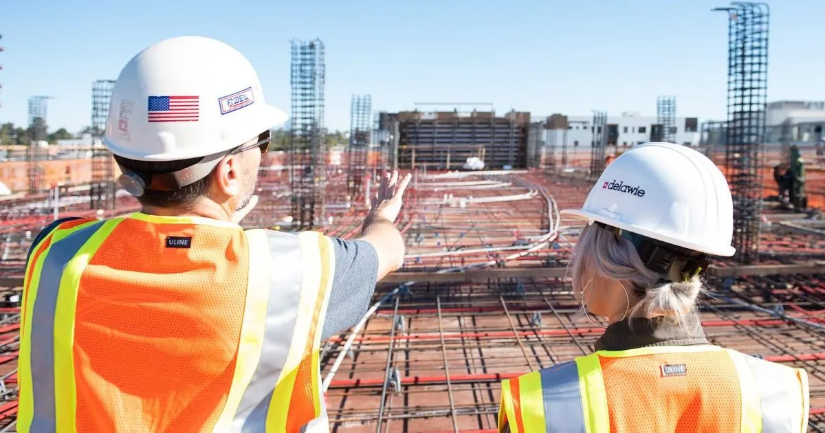Procurement Methods in Construction: man in white hard hat standing on brown wooden dock during daytime
