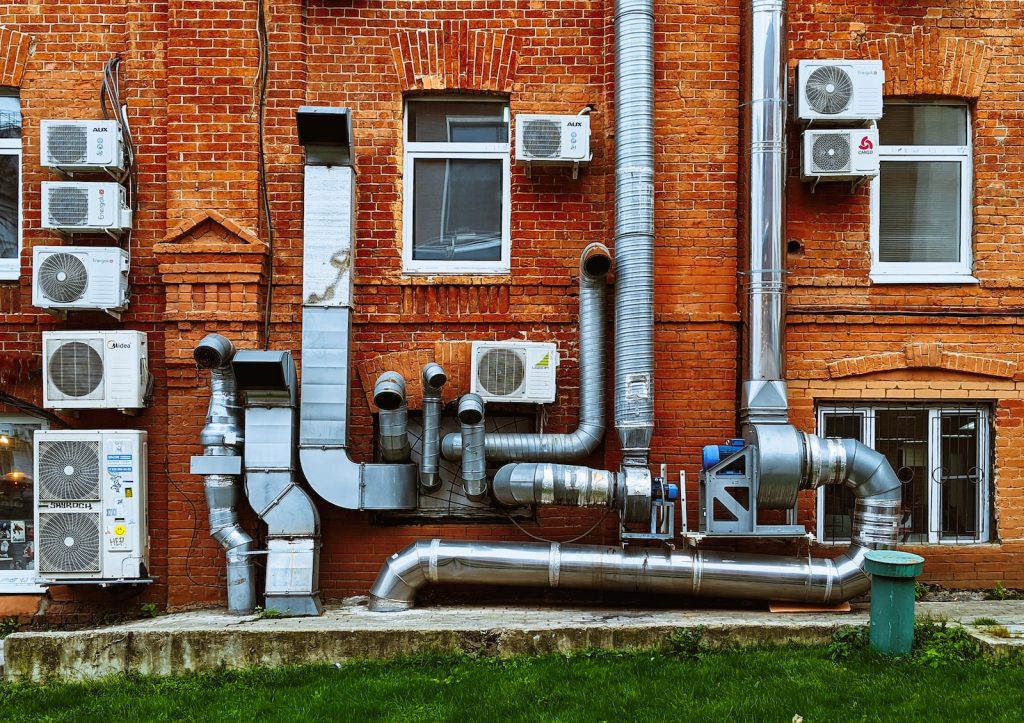 a building with a bunch of pipes on the side of it, AC, HVAC, Mechanical, M&E Stand For in Construction