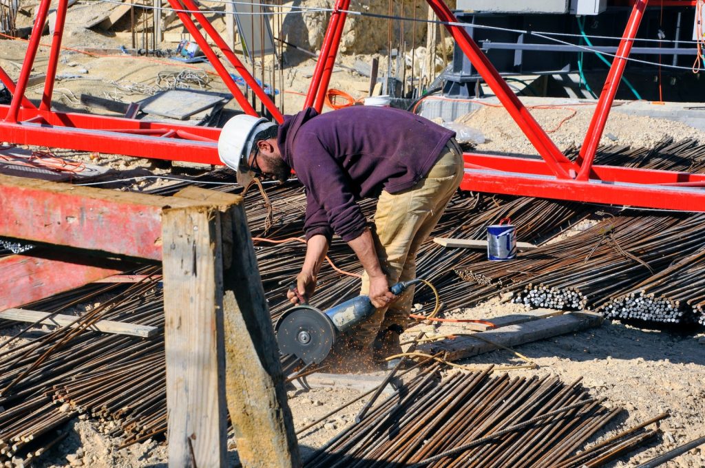 a person working on a construction site : Rebar cutting