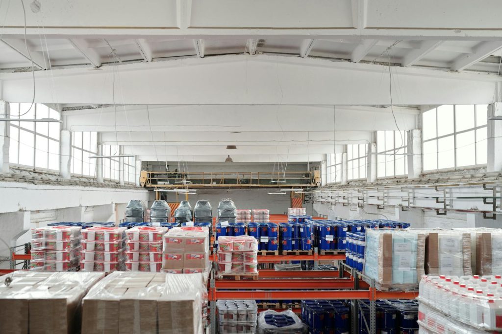 Construction Off-site Material store, Spacious warehouse interior featuring organized shelves with various stacked pallets.